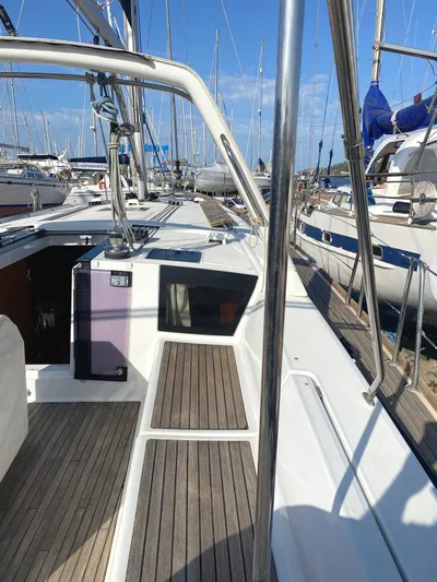  Yacht Photos Pics 2014 Beneteau Oceanis 45 sailboat deck with wooden flooring in marina.