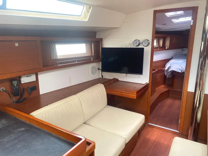  Yacht Photos Pics Interior of 2014 Beneteau Oceanis 45 yacht with seating, TV, and cabin view.