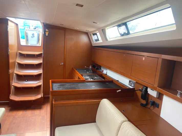  Yacht Photos Pics Interior of 2014 Beneteau Oceanis 45 yacht with modern kitchen and wooden cabinetry.