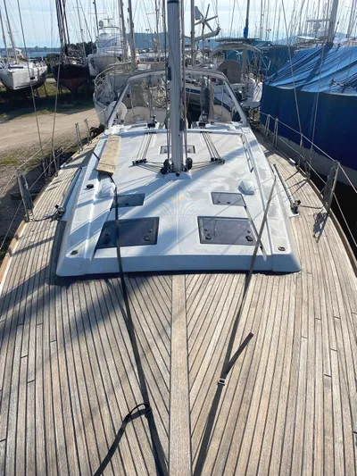  Yacht Photos Pics 2014 Beneteau Oceanis 45 sailboat with wooden deck and sleek design.