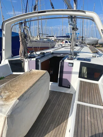  Yacht Photos Pics 2014 Beneteau Oceanis 45 sailboat with spacious deck and marina background.