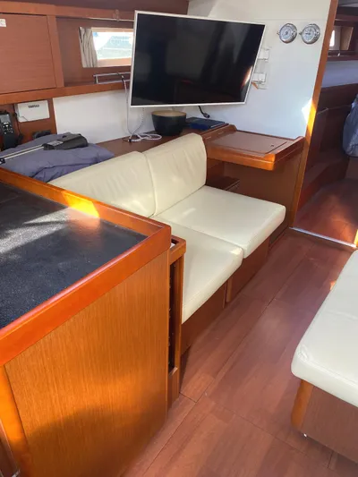 Yacht Photos Pics Interior of 2014 Beneteau Oceanis 45 yacht with modern seating and mounted TV.