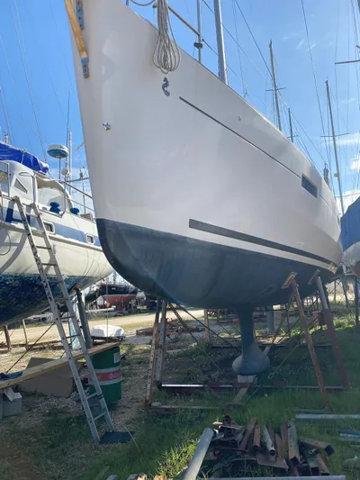  Yacht Photos Pics 2014 Beneteau Oceanis 45 sailboat on dry dock, side view, with clear blue sky.