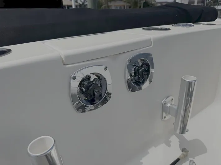  Yacht Photos Pics 2004 Intrepid 32 Cuddy boat deck with chrome fittings and rod holders.