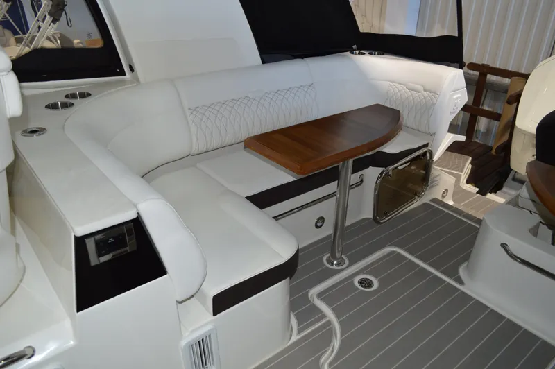  Yacht Photos Pics 2023 Sea Ray DAO 370 interior with white seating and wooden table.