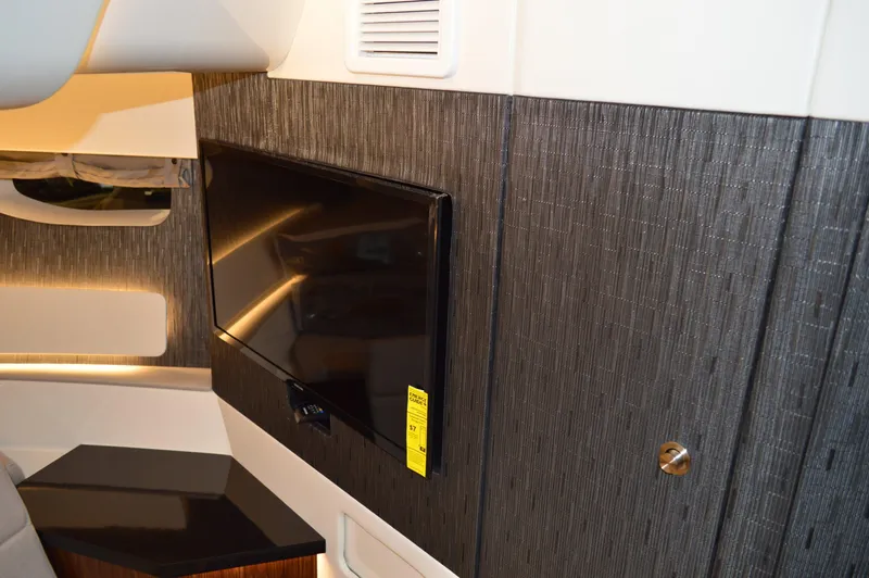  Yacht Photos Pics 2023 Sea Ray DAO 370 interior with mounted TV and modern wood paneling.