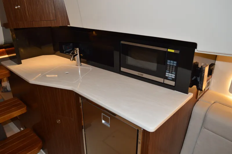  Yacht Photos Pics Modern kitchen area in 2023 Sea Ray DAO 370 yacht with microwave and sink.
