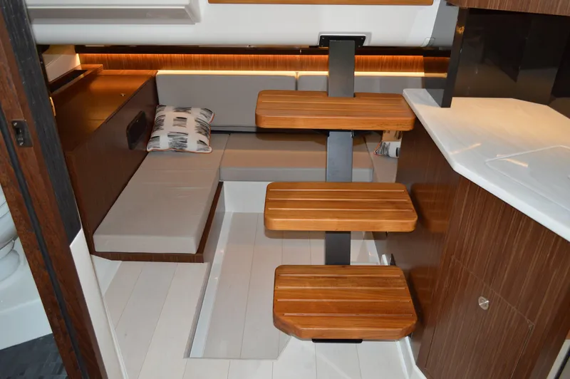  Yacht Photos Pics 2023 Sea Ray DAO 370 interior with wooden steps and modern seating area.