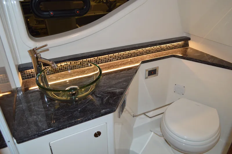  Yacht Photos Pics Luxurious bathroom in 2023 Sea Ray DAO 370 yacht with glass sink and modern fixtures.
