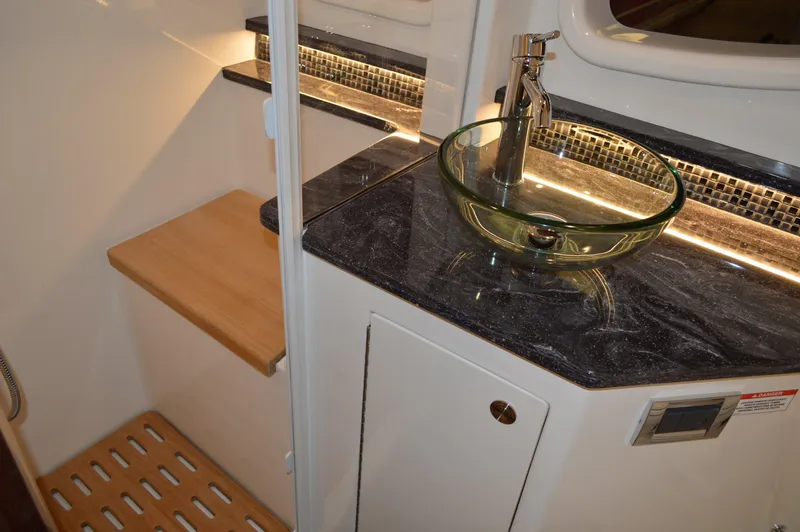  Yacht Photos Pics Luxurious bathroom interior of 2023 Sea Ray DAO 370 yacht with modern glass sink.