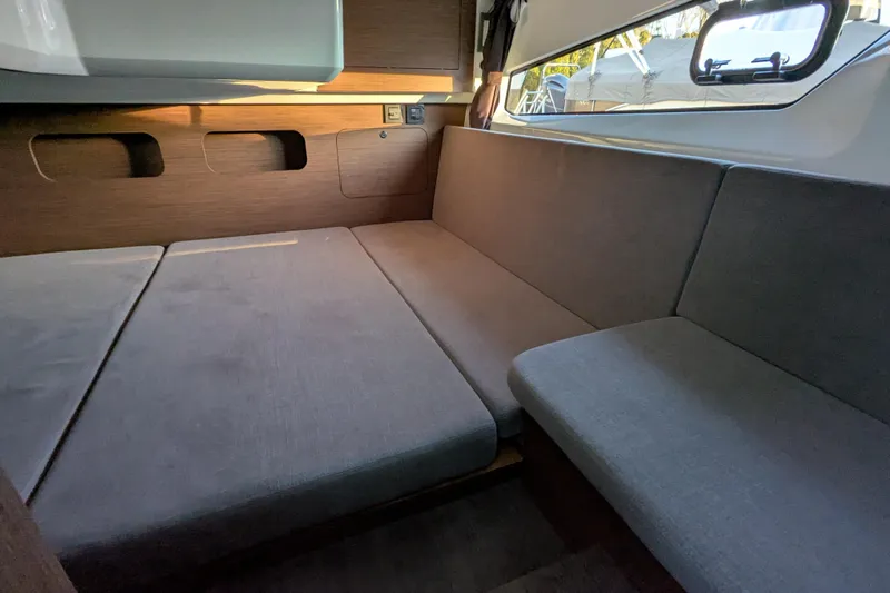 Yacht Photos Pics Interior of 2024 Beneteau Antares 11, featuring a cozy seating area with modern design.