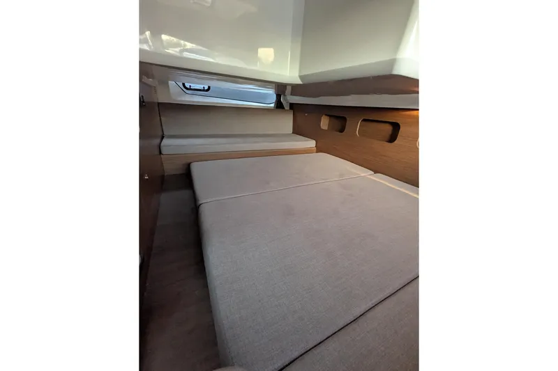  Yacht Photos Pics 2024 Beneteau Antares 11 cabin interior with cozy bed and modern design.