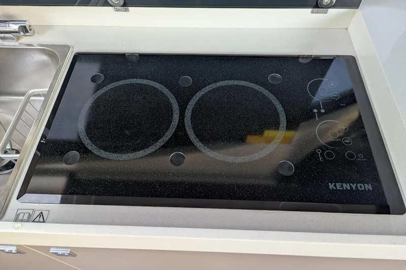  Yacht Photos Pics 2024 Beneteau Antares 11 kitchen with Kenyon electric cooktop.