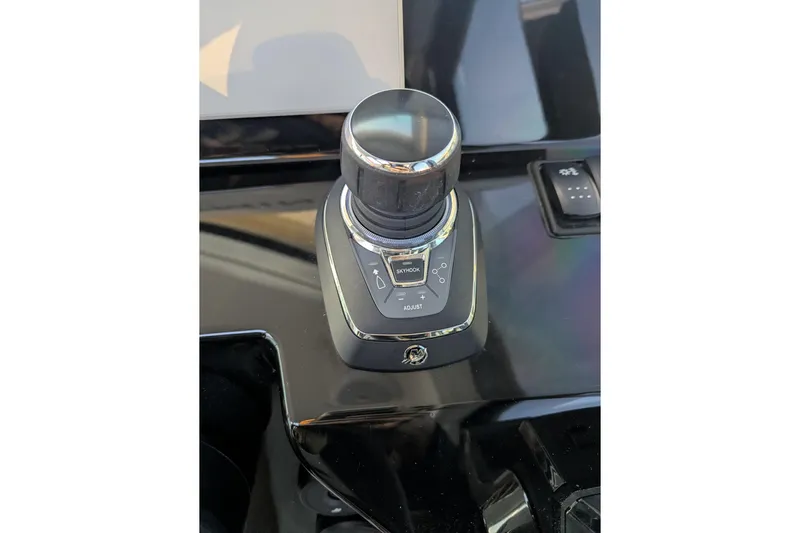  Yacht Photos Pics 2024 Beneteau Antares 11 joystick control on sleek black dashboard.