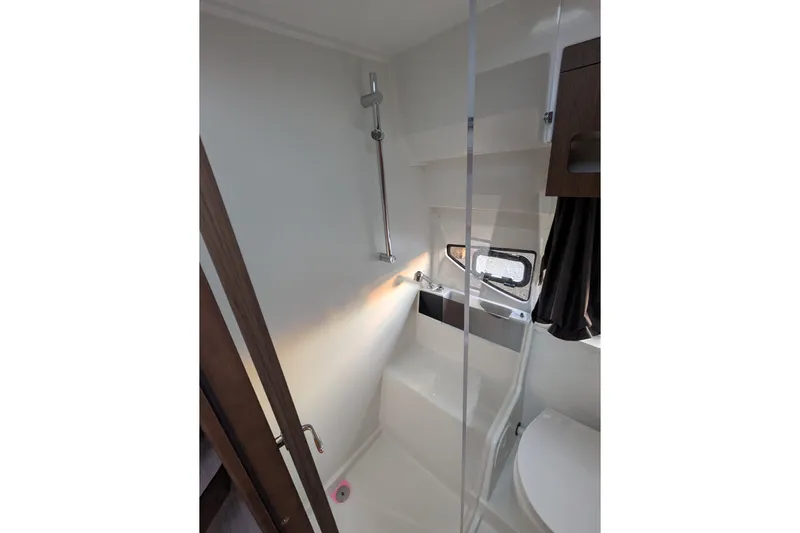  Yacht Photos Pics 2024 Beneteau Antares 11 bathroom with shower, window, and modern fixtures.