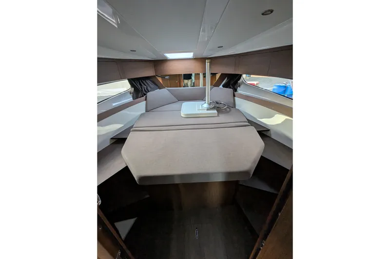  Yacht Photos Pics 2024 Beneteau Antares 11 cabin interior with modern design and comfortable seating.