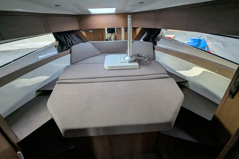  Yacht Photos Pics Interior cabin of 2024 Beneteau Antares 11 with modern seating and table.
