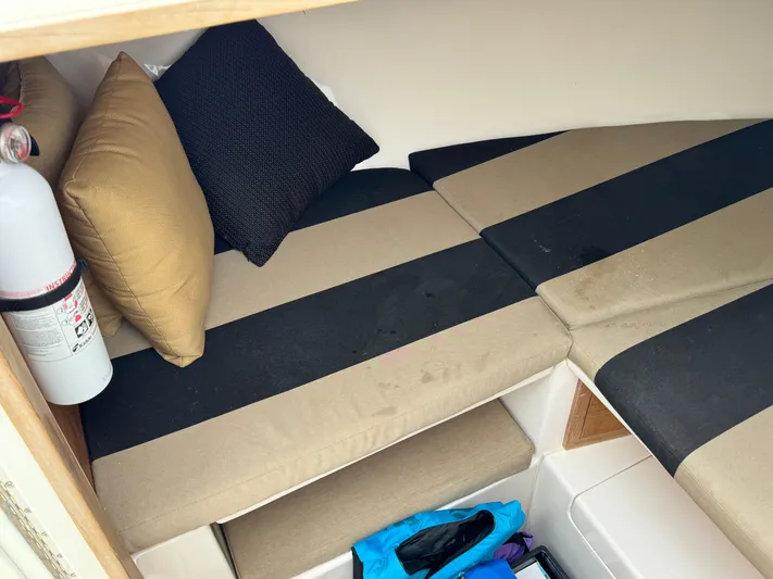  Yacht Photos Pics 2004 Intrepid 32 Cuddy cabin interior with striped cushions and pillows.