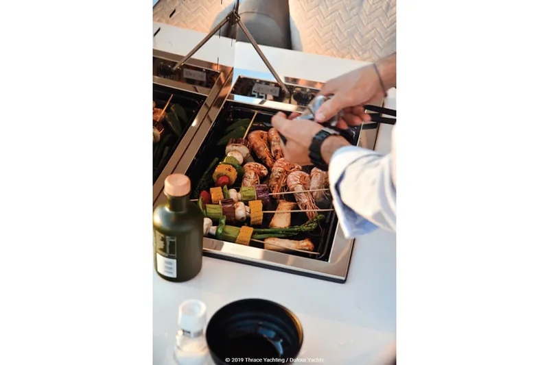  Yacht Photos Pics Grilling skewers and vegetables on a Dufour Catamarans 48, 2020 model.