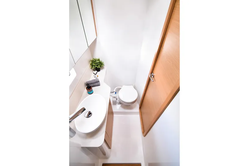  Yacht Photos Pics Bathroom interior of 2020 Dufour Catamarans 48, featuring modern sink and toilet.