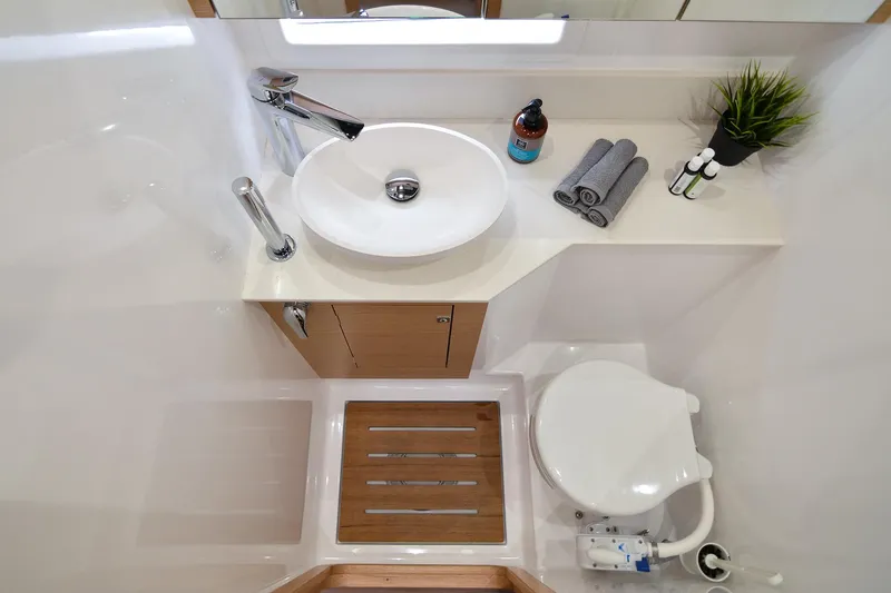  Yacht Photos Pics Modern bathroom in 2020 Dufour Catamarans 48, featuring sleek sink and compact toilet.