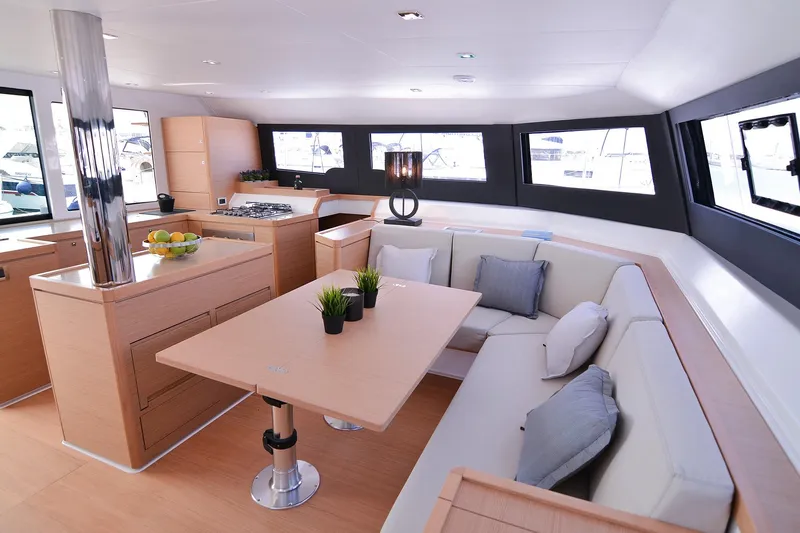  Yacht Photos Pics Luxurious interior of 2020 Dufour Catamarans 48 with modern kitchen and cozy seating area.