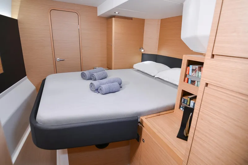  Yacht Photos Pics Luxurious cabin interior of 2020 Dufour Catamarans 48 with cozy bed and wooden finish.
