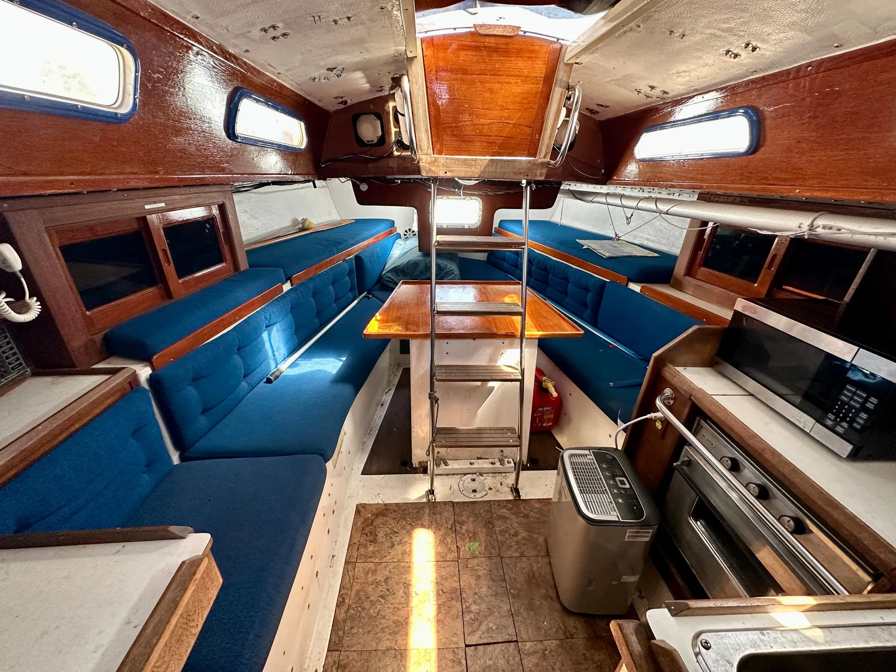 Interior of a 1982 Schock NY 36 yacht with blue upholstery.