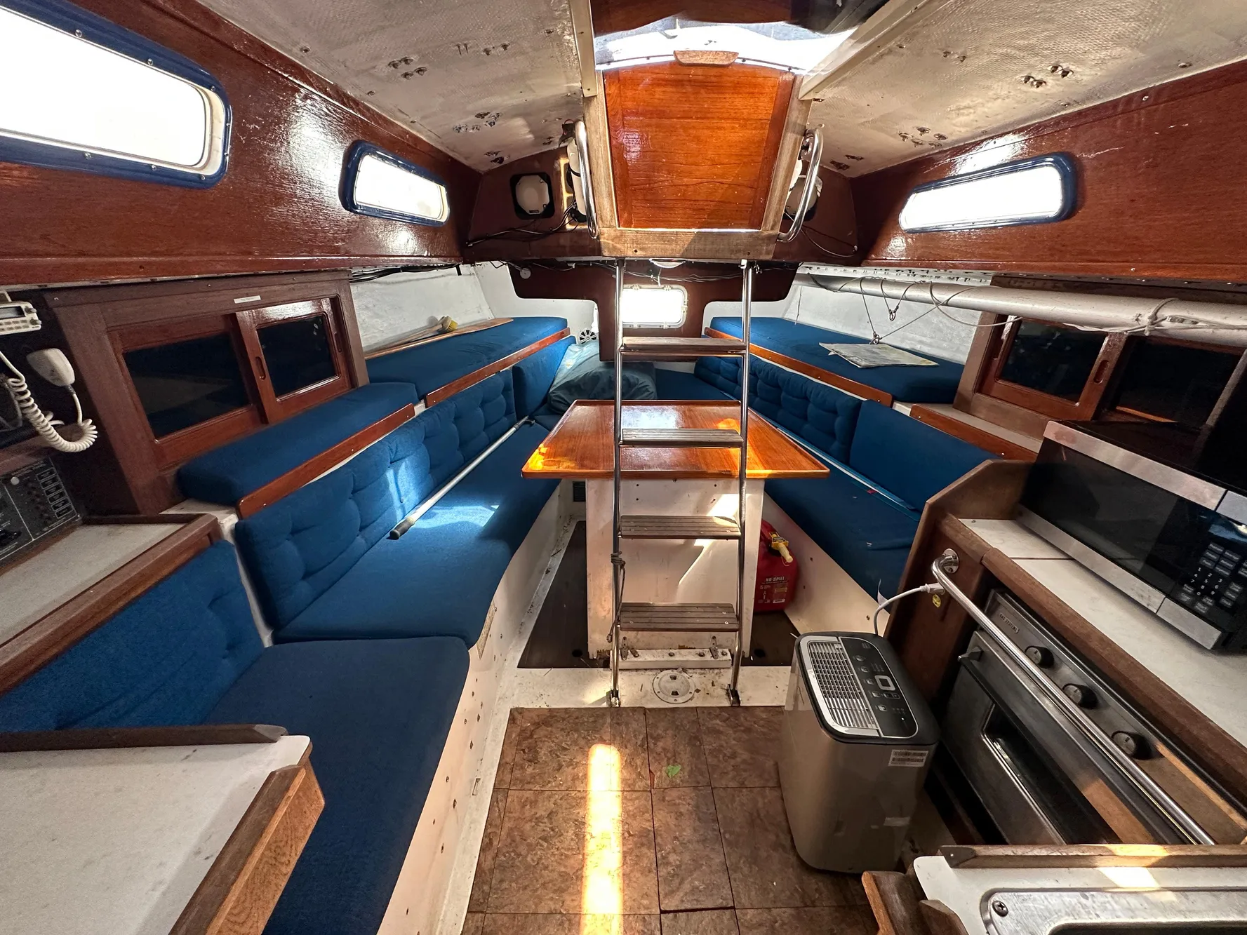 Interior of a 1982 Schock NY 36 yacht with blue upholstery.