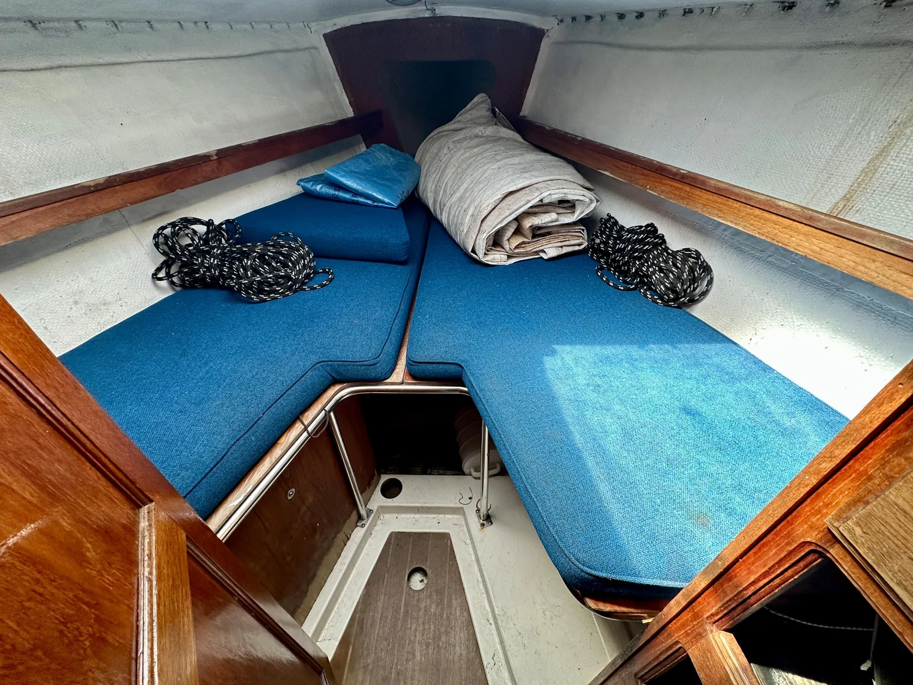Interior of a 1982 Schock NY 36 yacht with blue cushions.