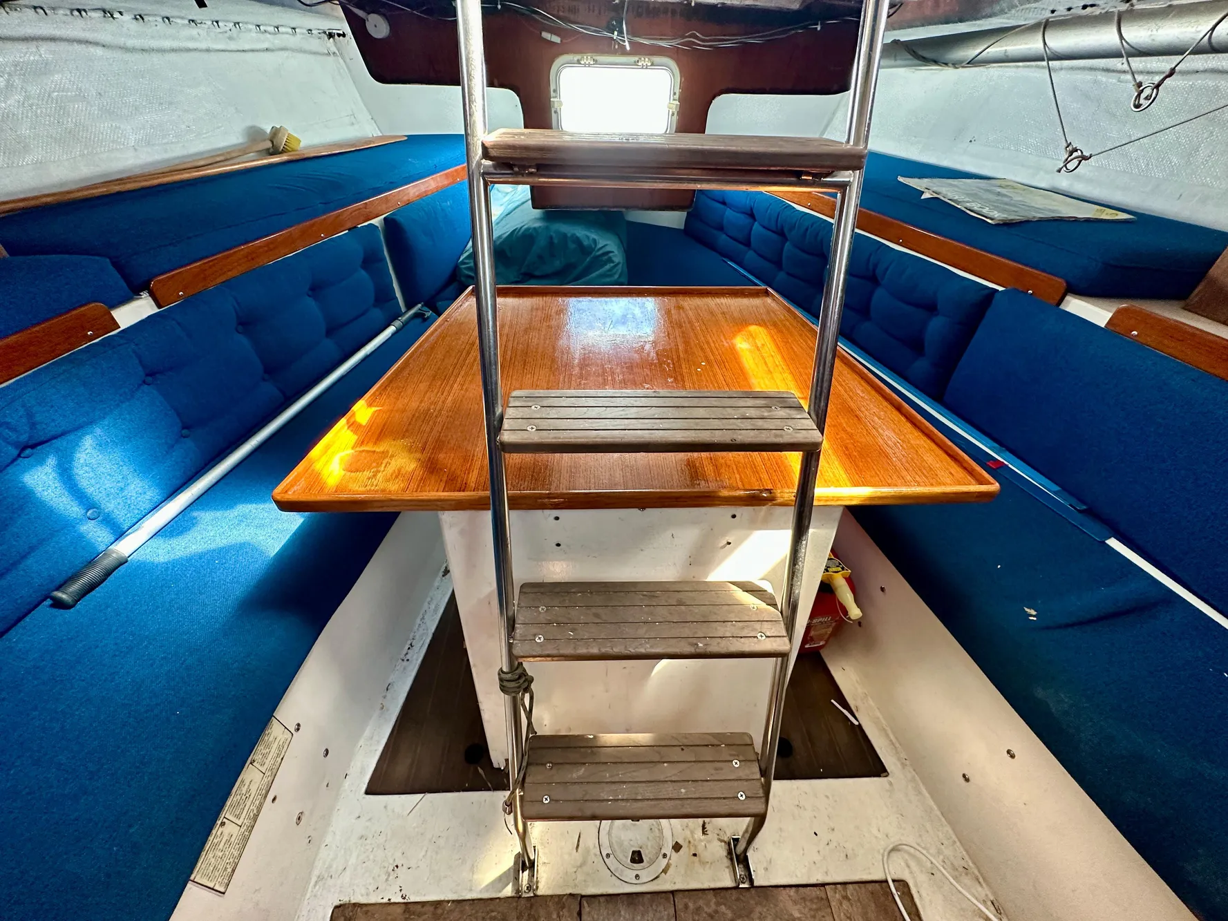 Interior of a 1982 Schock NY 36 yacht with blue seating.