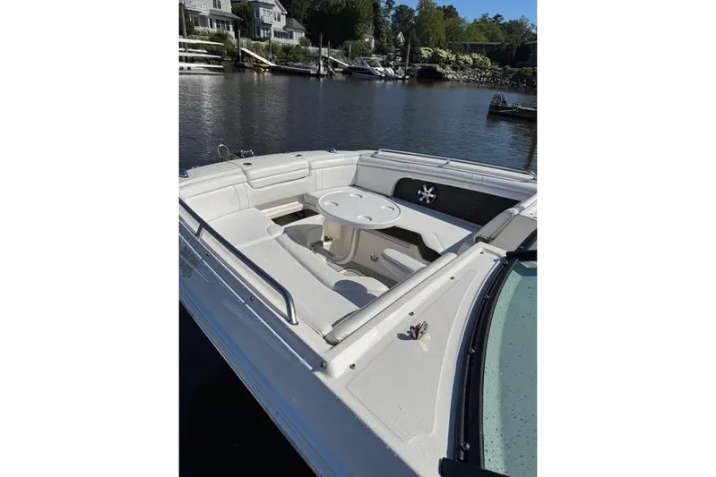  Yacht Photos Pics 2019 Sea Ray SDX 290 Outboard boat with spacious seating and table on calm water.