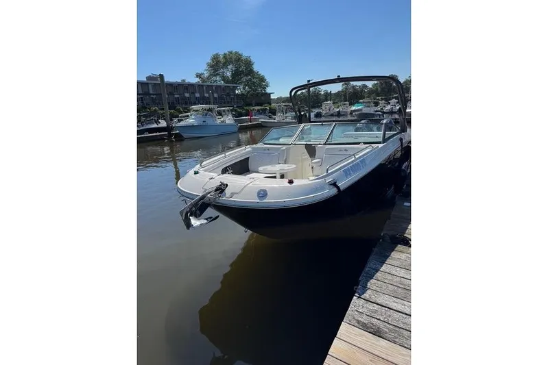 Yacht Photos Pics 2019 Sea Ray SDX 290 Outboard boat docked in a marina under clear skies.