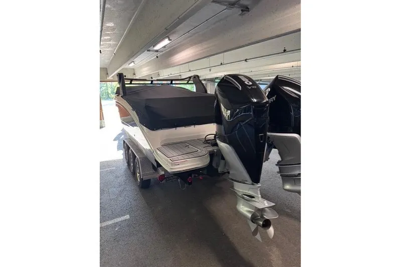  Yacht Photos Pics 2019 Sea Ray SDX 290 Outboard boat with dual engines in a covered parking area.