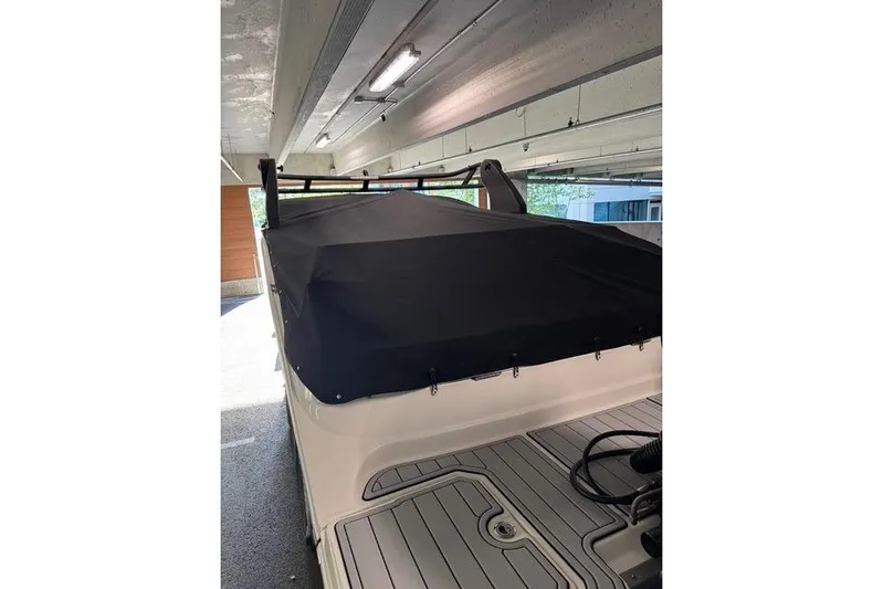  Yacht Photos Pics 2019 Sea Ray SDX 290 Outboard covered in a garage, showcasing rear deck and protective cover.