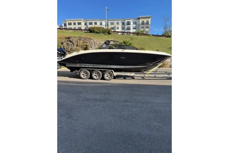  Yacht Photos Pics 2019 Sea Ray SDX 290 Outboard boat on a trailer, parked roadside.