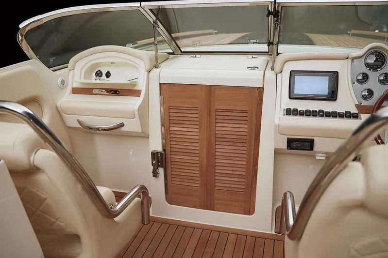  Yacht Photos Pics Manufacturer Provided Image: 2016 Chris-Craft Corsair 32 cockpit with wooden accents and modern controls.