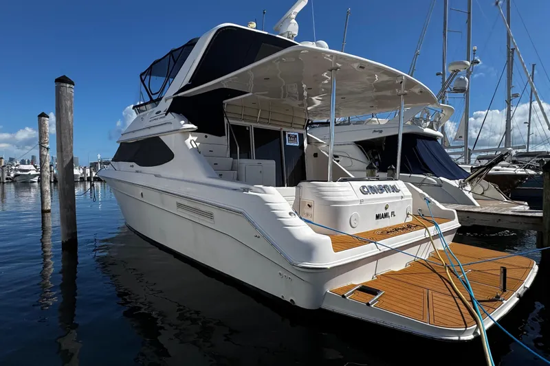  Yacht Photos Pics 1999 Sea Ray 440 Express Bridge yacht docked in marina, Miami, Florida.