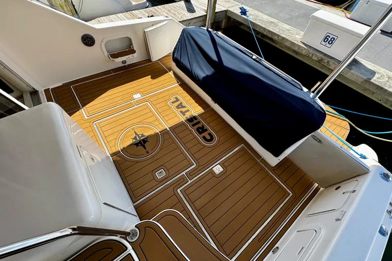  Yacht Photos Pics 1999 Sea Ray 440 Express Bridge deck with custom wood flooring and compass design.