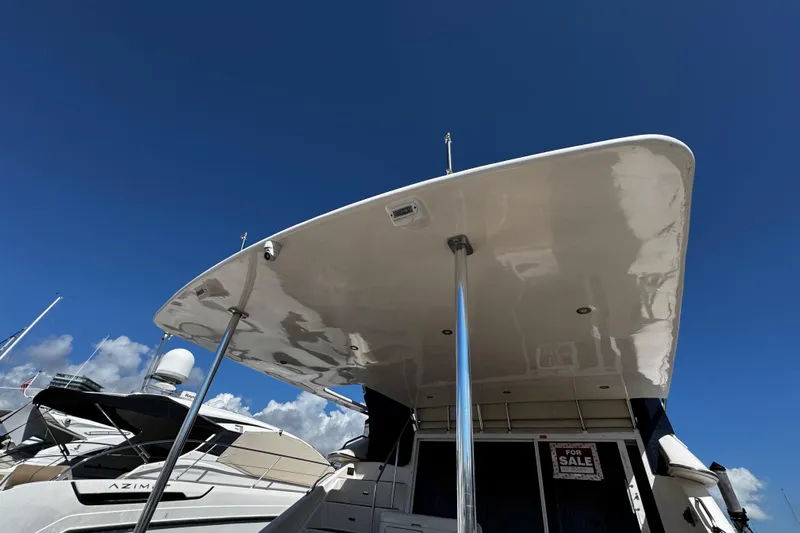  Yacht Photos Pics 1999 Sea Ray 440 Express Bridge yacht with "For Sale" sign under clear blue sky.