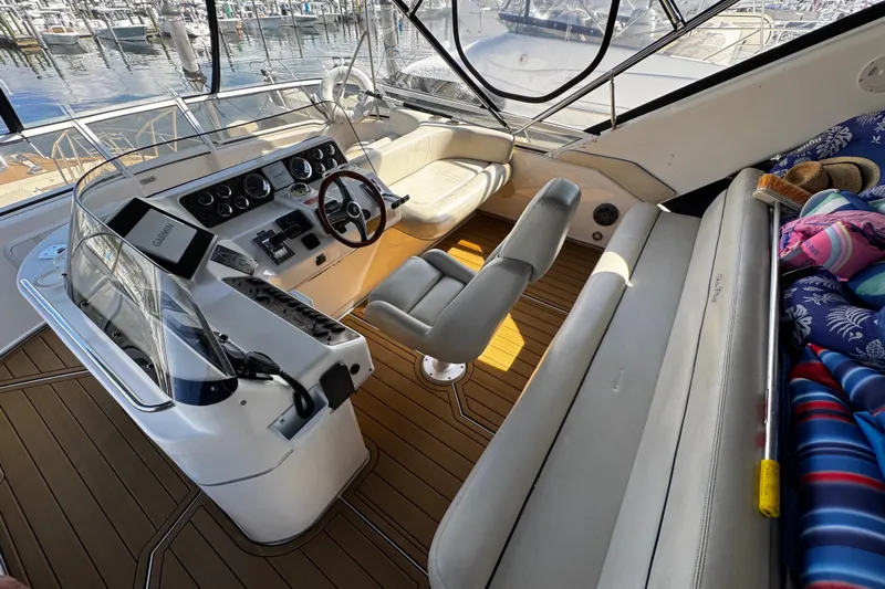  Yacht Photos Pics 1999 Sea Ray 440 Express Bridge cockpit with helm, seating, and marina view.
