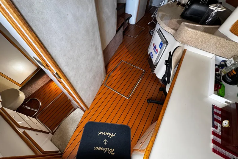  Yacht Photos Pics 1999 Sea Ray 440 Express Bridge interior with wood flooring and modern amenities.