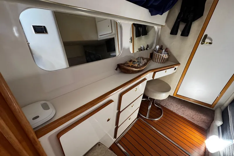  Yacht Photos Pics 1999 Sea Ray 440 Express Bridge interior with vanity, mirror, and stool.