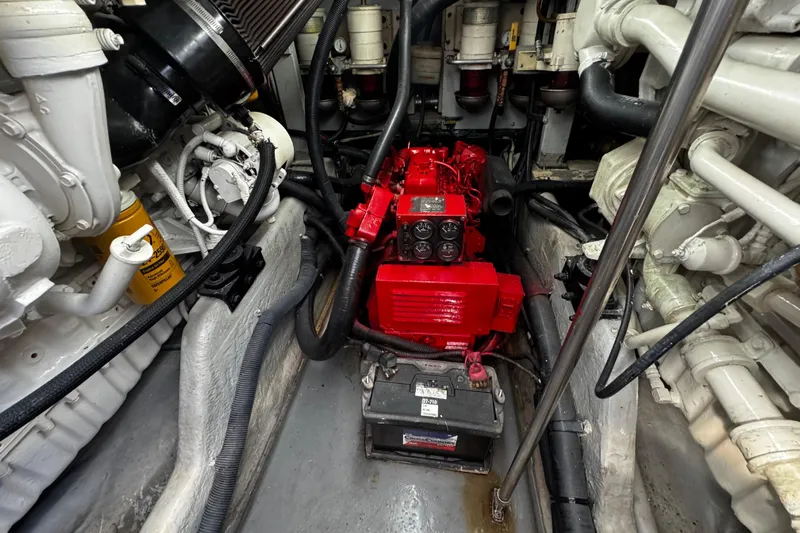  Yacht Photos Pics Engine room of a 1999 Sea Ray 440 Express Bridge with visible components and battery.