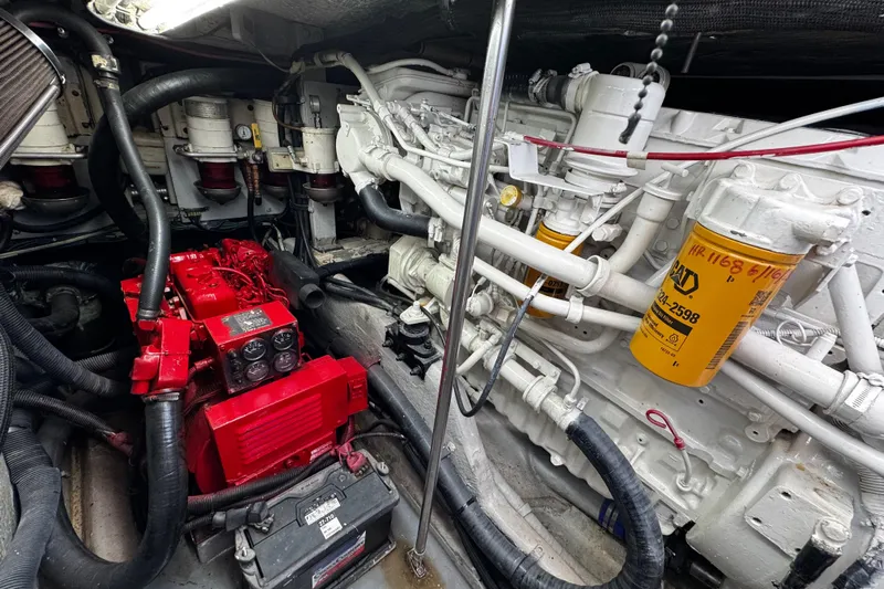  Yacht Photos Pics Engine room of a 1999 Sea Ray 440 Express Bridge, featuring red and white components.