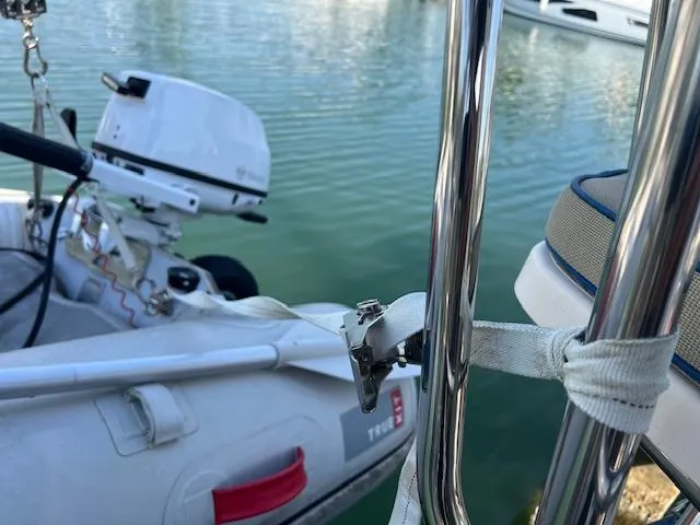  Yacht Photos Pics Inflatable boat with motor docked near Island Packet 380, 1999 model, on calm water.