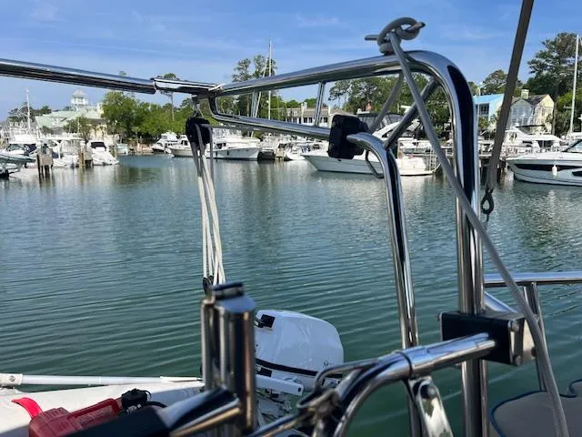  Yacht Photos Pics Island Packet 380 sailboat in marina, surrounded by calm water and other boats, sunny day.