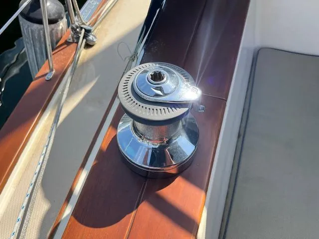  Yacht Photos Pics Winch on 1999 Island Packet 380 sailboat, sunlight reflecting on polished metal.