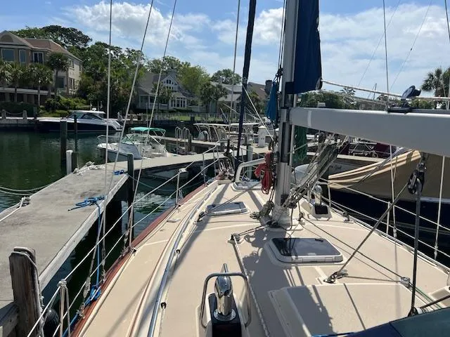  Yacht Photos Pics Sailboat docked at marina, Island Packet 380, 1999 model, sunny day, residential backdrop.