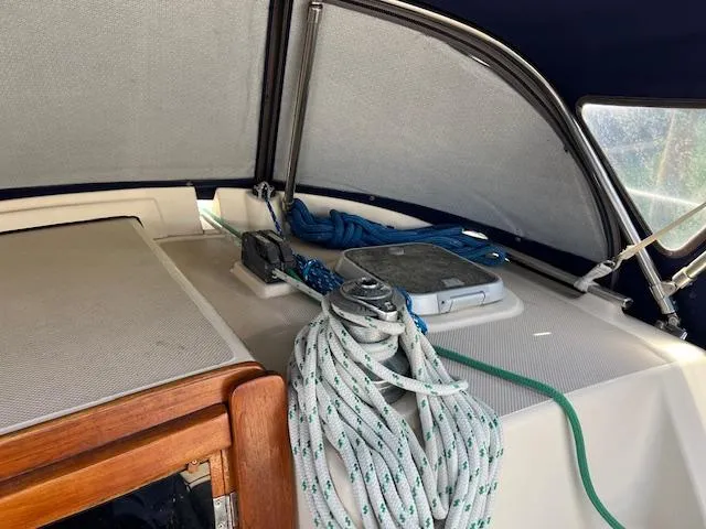  Yacht Photos Pics 1999 Island Packet 380 sailboat cockpit with ropes and hatch under canopy.